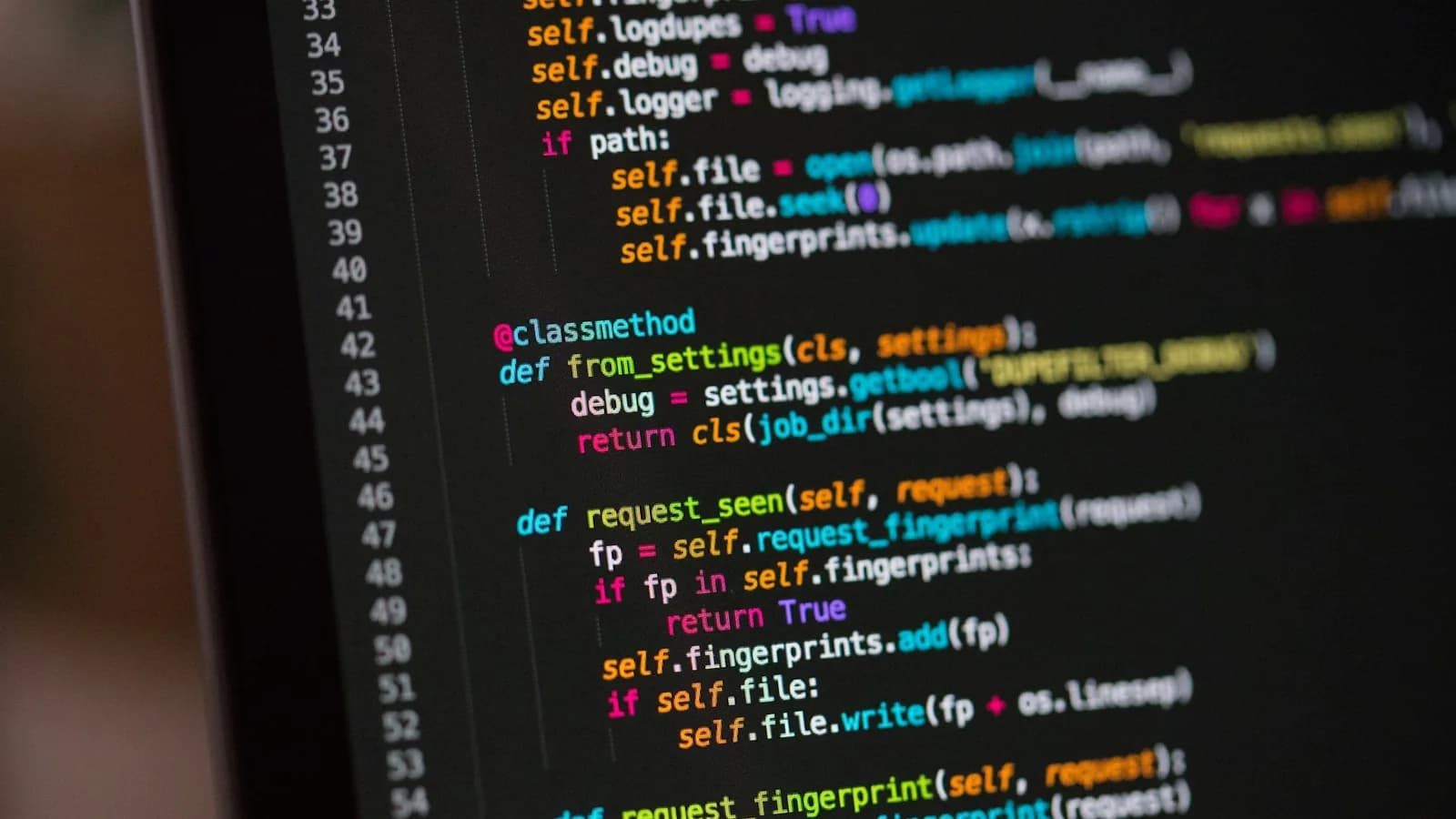 Developer workstation with code, terminal traces, and debugging tools open across multiple monitors