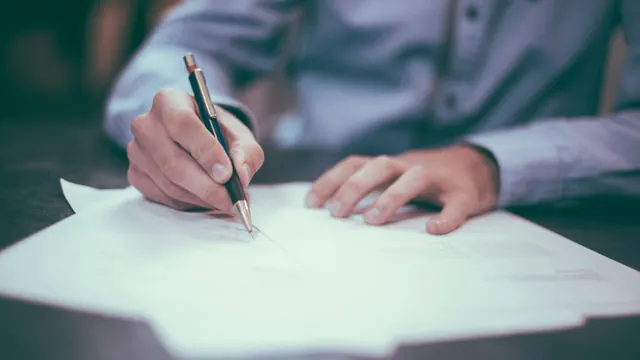 Compliance documents and financial charts reviewed on a conference table