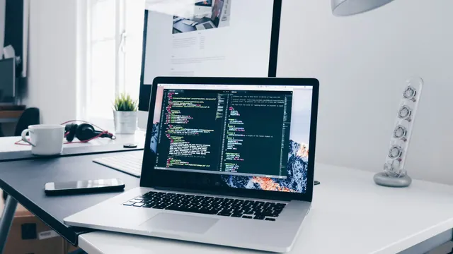 Developer analyzing analytics dashboards across multiple monitors