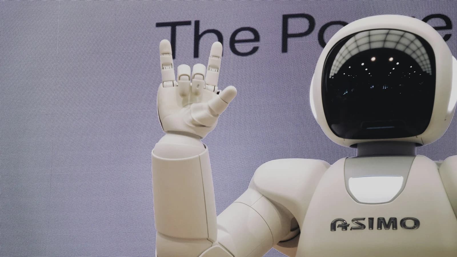 A humanoid robot and engineer working in a robotics lab
